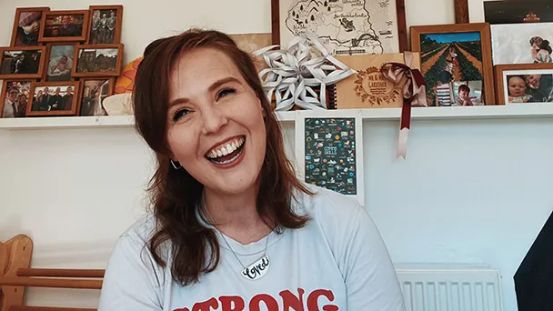 Zoe Gardiner wearing a Stong Girls Club t-shirt Zoe laughing in a "Strong Girls Club" t-shirt